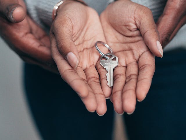 someone holding keys in their cupped hands